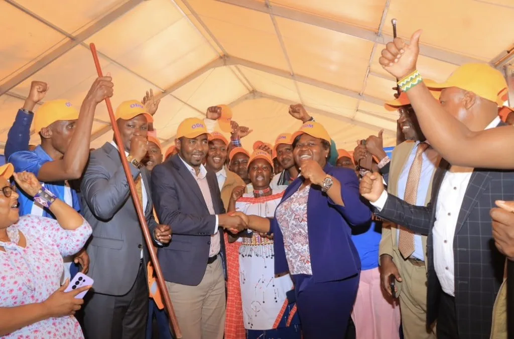 ODM National Chairperson Gladys Wanga welcomes Gideon Mayian Saruni to the party by placing an ODM cap on him during a ceremony at Chungwa House in Nairobi on October 6, 2026