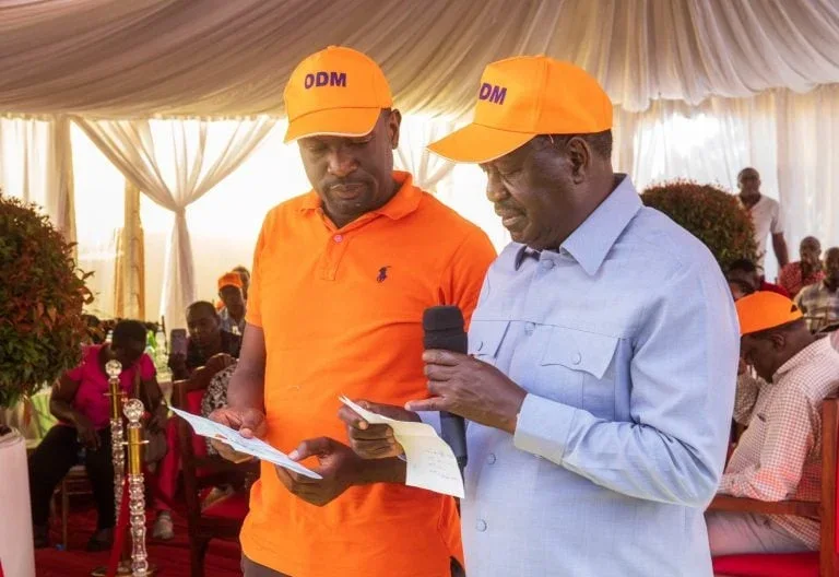 The late Raila Odinga and Nairobi Senator Edwin Sifuna.