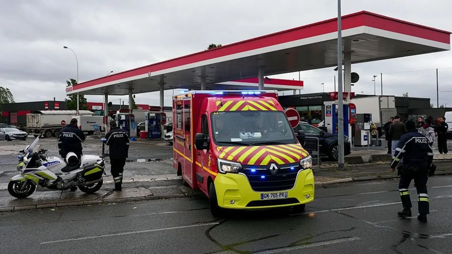French firefighters and police were seen at a petrol station in the area