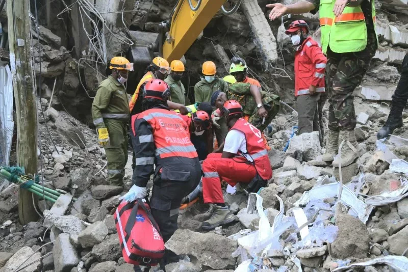 Kenya Red Cross rescuers carry a man who was trapped in the 18-storey building that collapsed in Eastleigh, Nairobi, on October 24, 2026